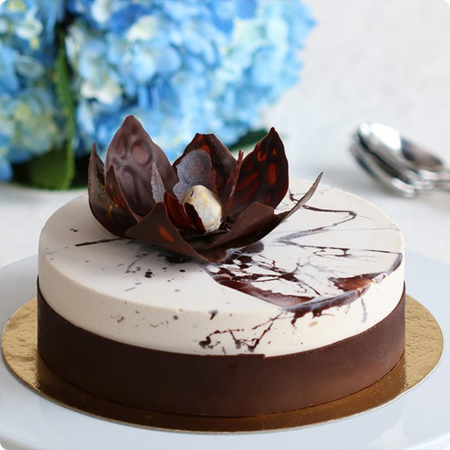 Botolino's Fior di Nocciola vegan cake — Nocciola d'Elite hazelnut spumone layered with Valrhona chocolate, topped with a handcrafted chocolate flower.